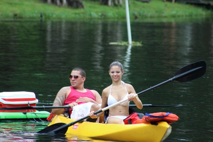 a group of people rowing a boat in the water